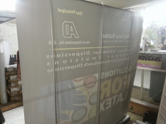 back view of a large backdrop banner standee being supported by 3 bars