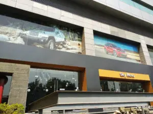 windows of a high rise building used for advertisements using one way vision film by the Jeep company