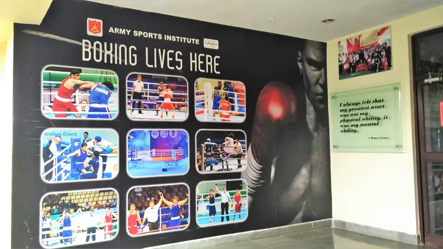 A wall mural made of a vinyl banner and pasted on the wall outside a boxing club. The wall sticker shows images of all the club’s boxing champions in action.