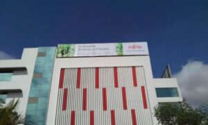 flex hoarding installed on the top of a very tall building at the Fujitsu Company