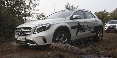 Mercedes company branding and printing on a car racing over a muddy road