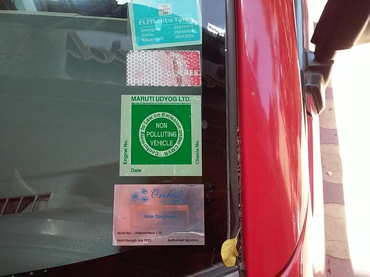 Parking stickers and permits pasted from behind the windscreen