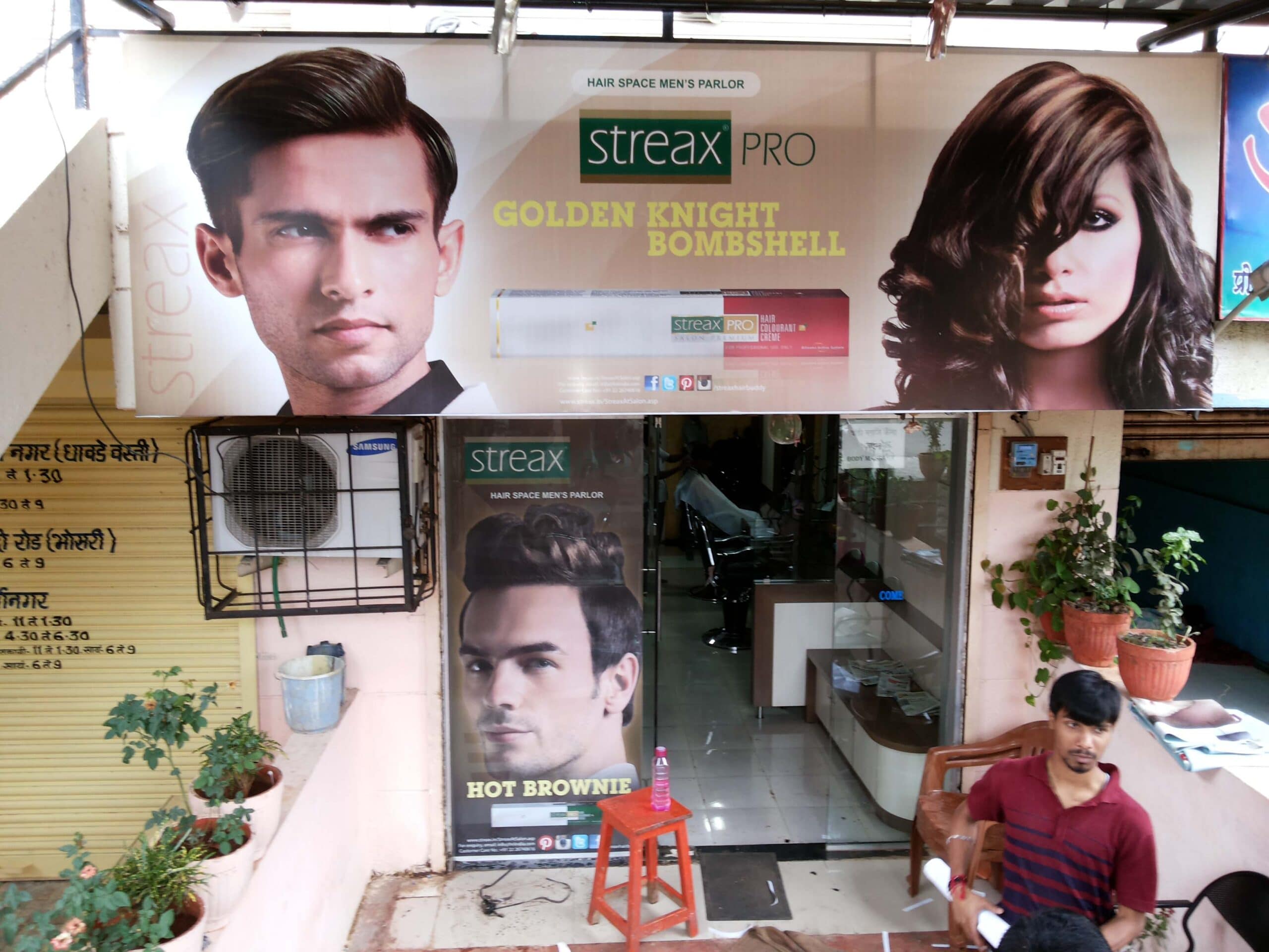 Front lit shop board and glass film prints used for product advertising at the Streax beauty saloon
