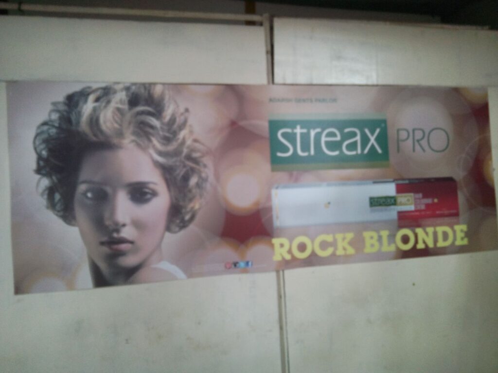 photo print advertising streax products pasted on the wall of a beauty salon