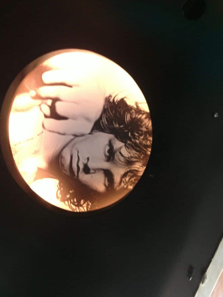 3d ceiling wallpaper having Jim Morrison’s photo lit from the edges by hidden lights