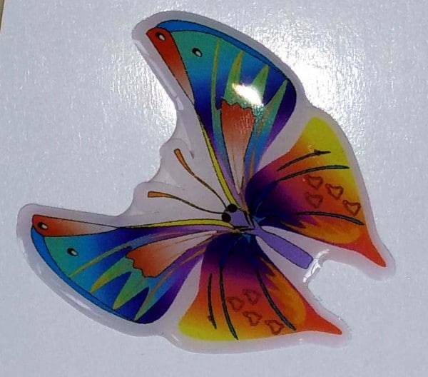 Domed label cut in the shape of a butterfly and given a gel coating