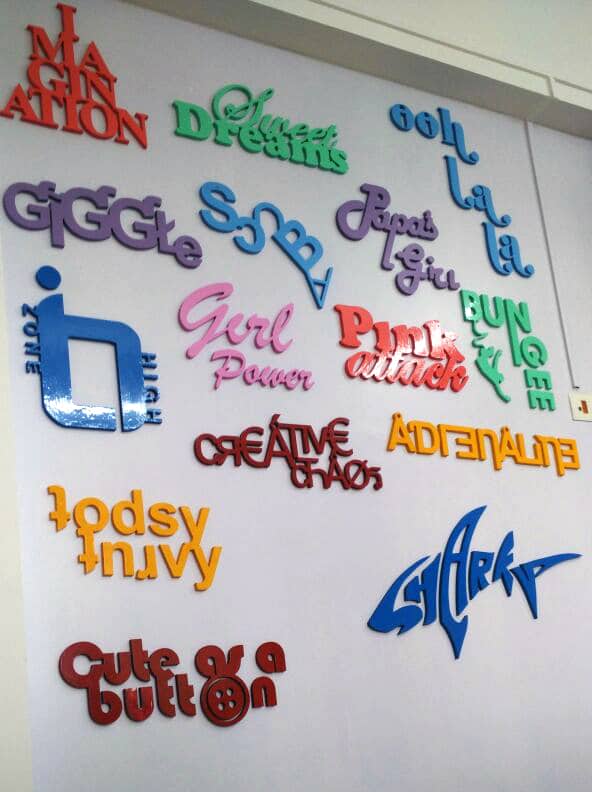 Words and phrases artistically cut on a CNC router to create 3D wall graffiti as an interior design idea for kids room