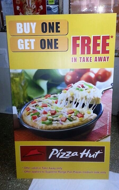 front view of a printed sunboard standee showing an ad for a Pizza Hut product