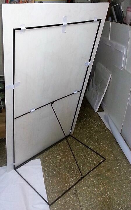 back view of a sunboard standee supported on the floor by a metal frame that can be folded