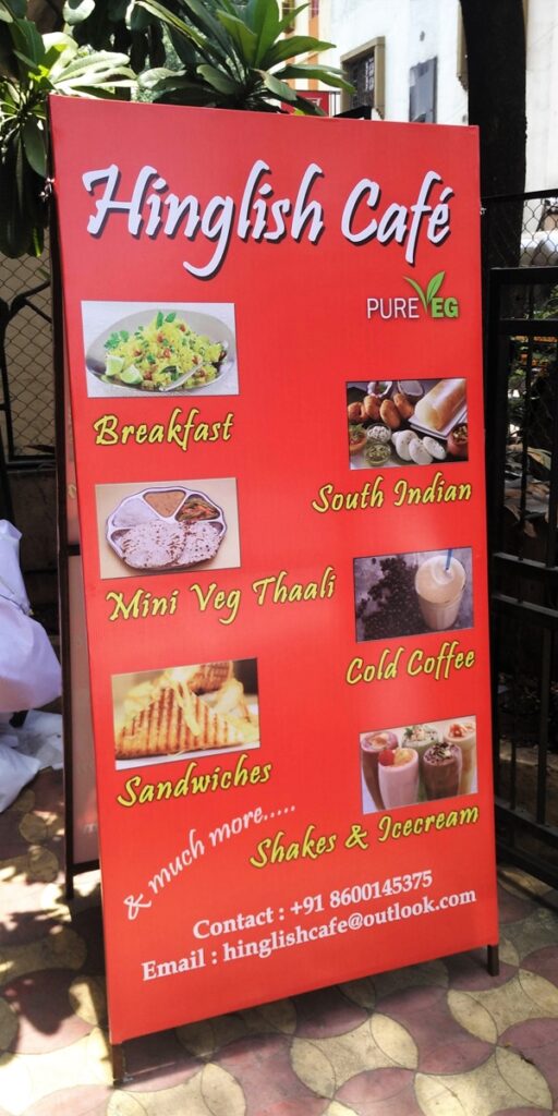 two sided flex stand showing food menu of hinglish cafe