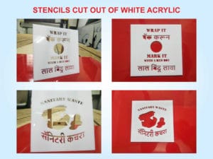 custom cut stencils made out of white acrylic for spray painting a packing box of used sanitary pads