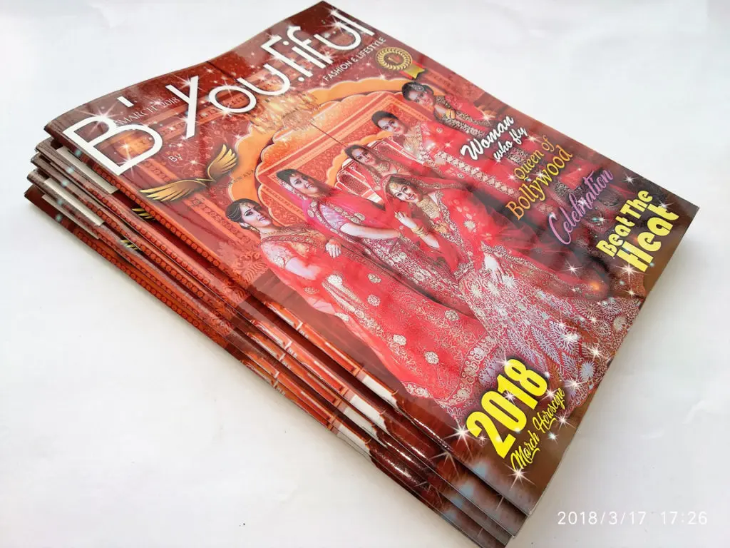 stack of laminated and center pinned brochures