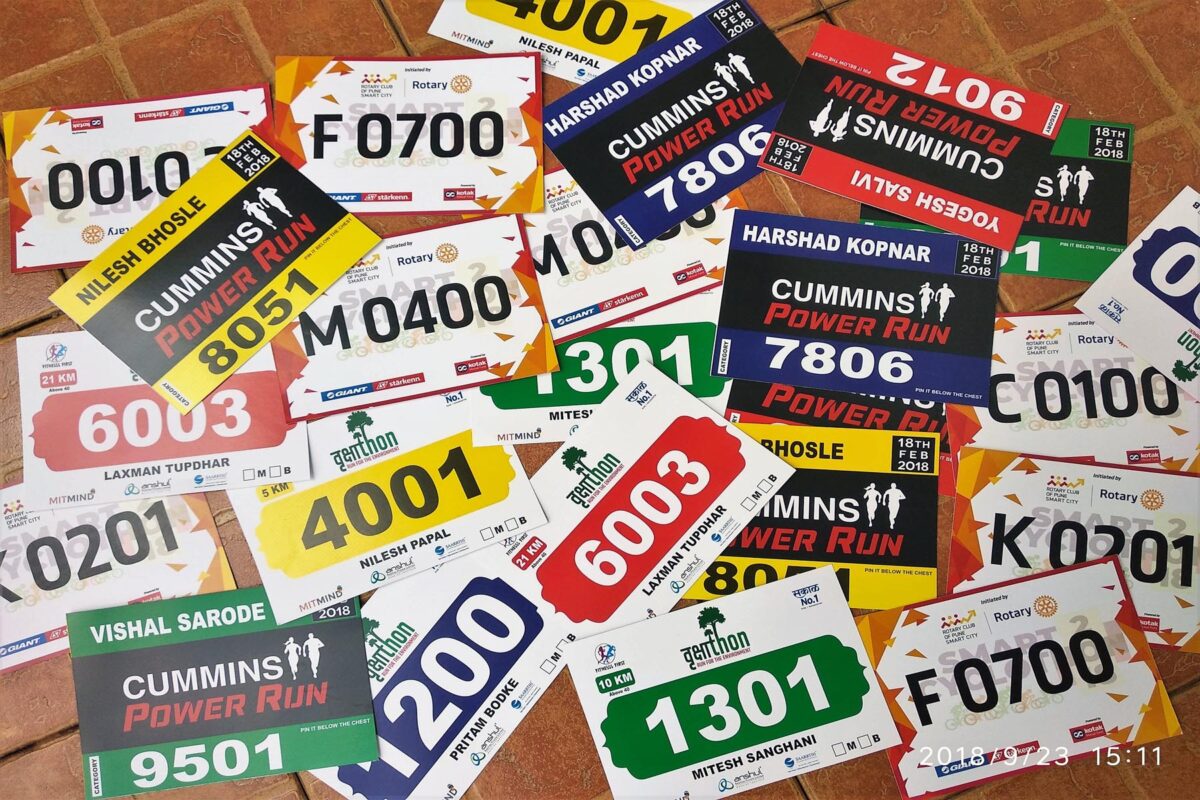 Marathon bibs with numbers, sponsors’ logos, & runner data