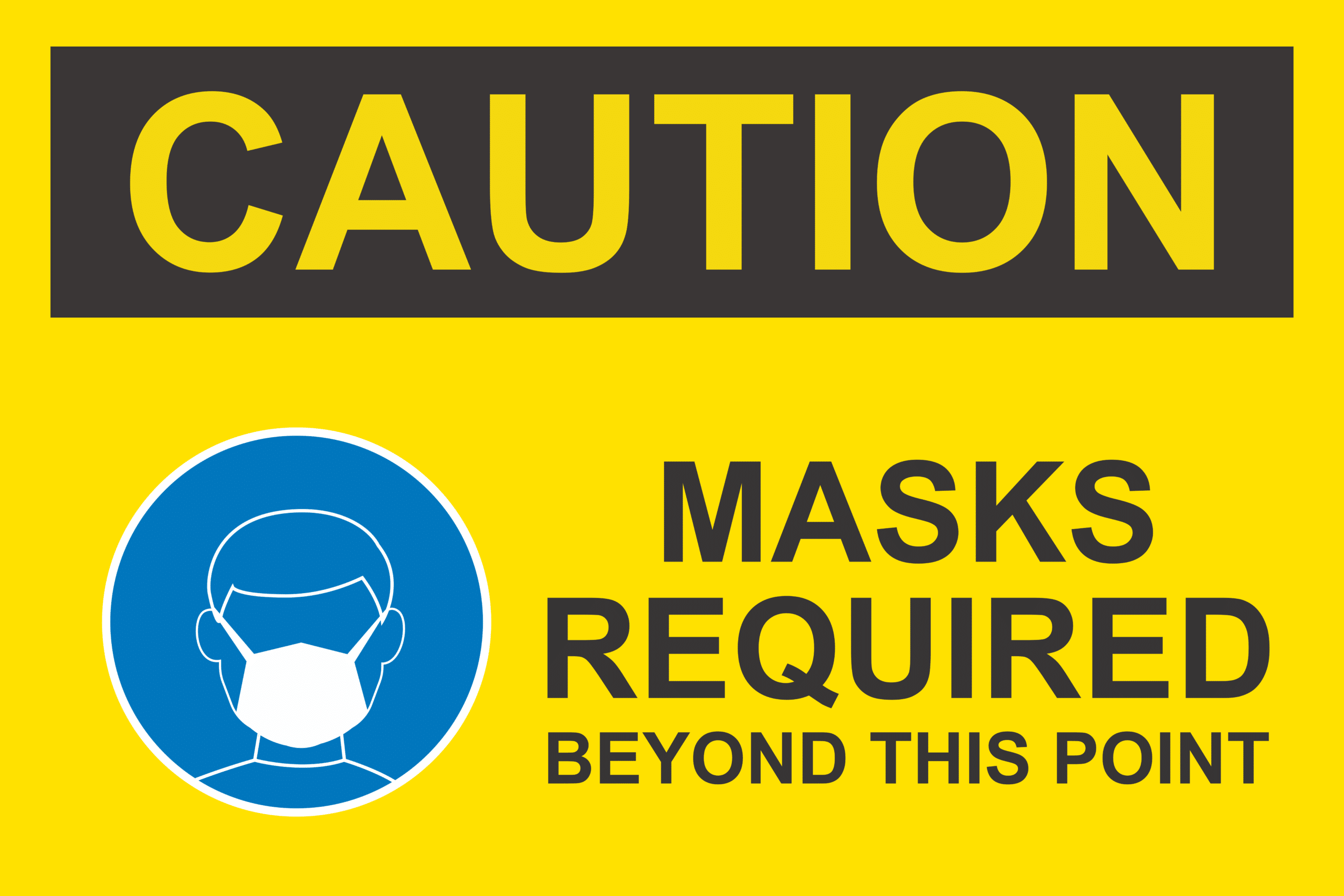 Covid 19 safety sign which reads caution masks required beyond this point as a precaution against the virus