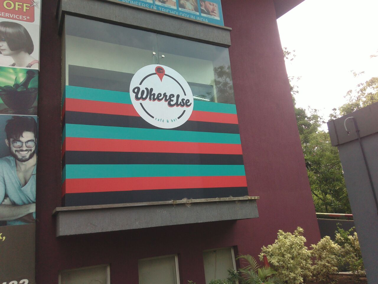 Huge logo of the Where Else Café printed on a opaque film and pasted on the glass frontage of the building