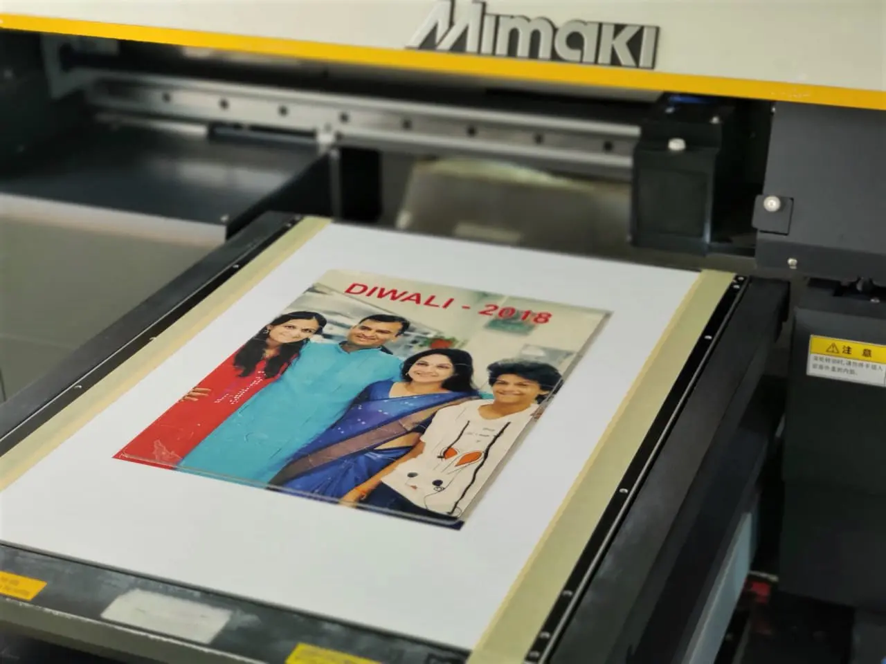 Mimaki Ultra Violet flatbed printer printing a family photo on a die cut jigsaw puzzle to create a great personalised gift