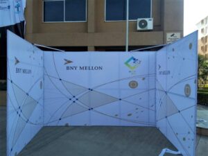 Stage backdrop with two side panels erected on a metal frame for an event at the BNY Mellon company