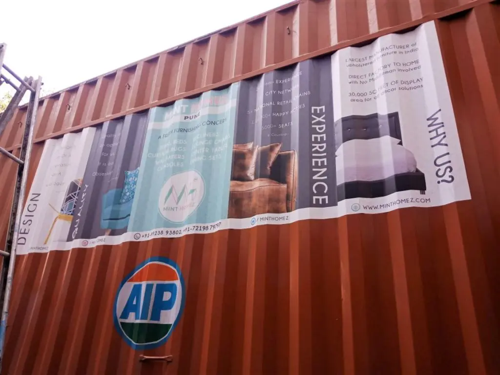 Commercial vehicle branding on the uneven corrugated surface of a container truck using all-weather, waterproof cast vinyl