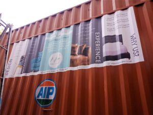 Commercial vehicle branding on the uneven corrugated surface of a container truck using UV printed cast vinyl