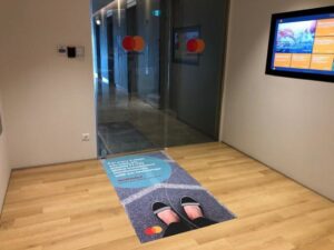 Novel ideas for office interior design involving the use of a floor sticker pasted on the ground to advertise a service of the Master Card company in an eye catching manner