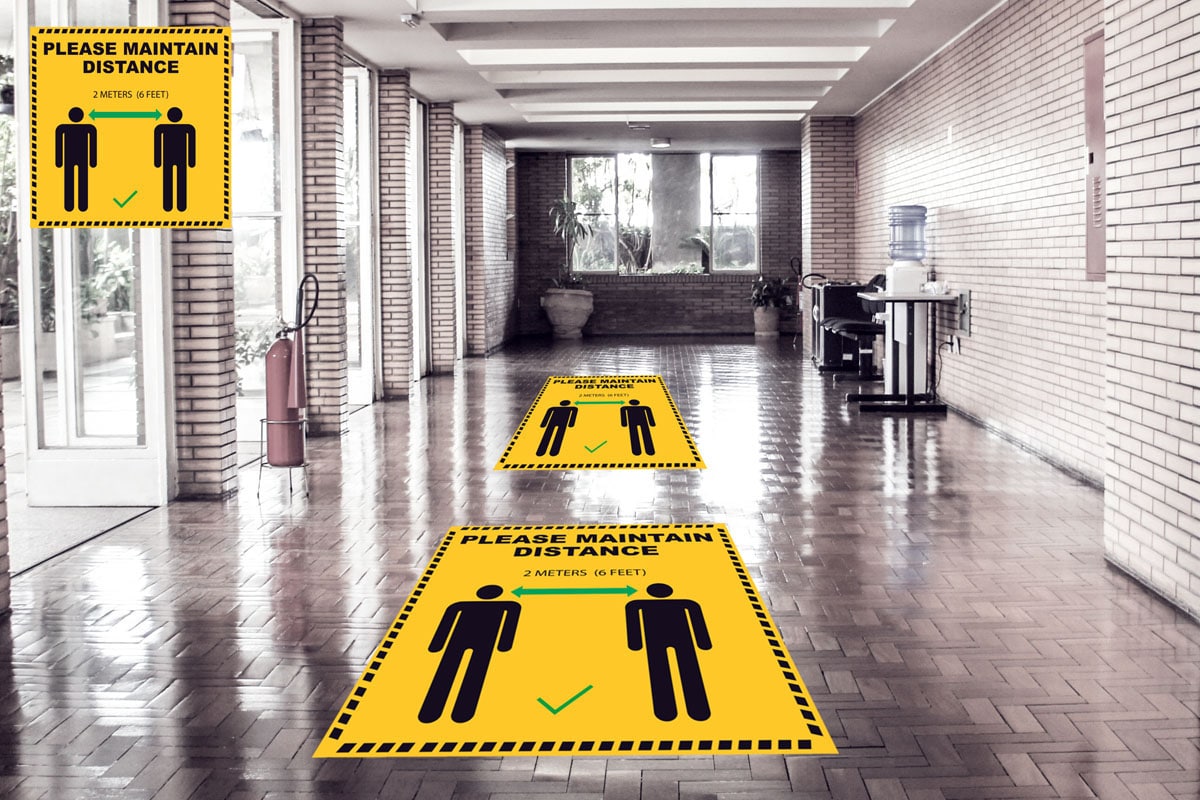 floor stickers and graphics for social distancing asking you to maintain 6 feet distance which are pasted on the ground
