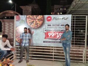 frontlit flex sign board on a metal frame showing advertisement for pizza hut