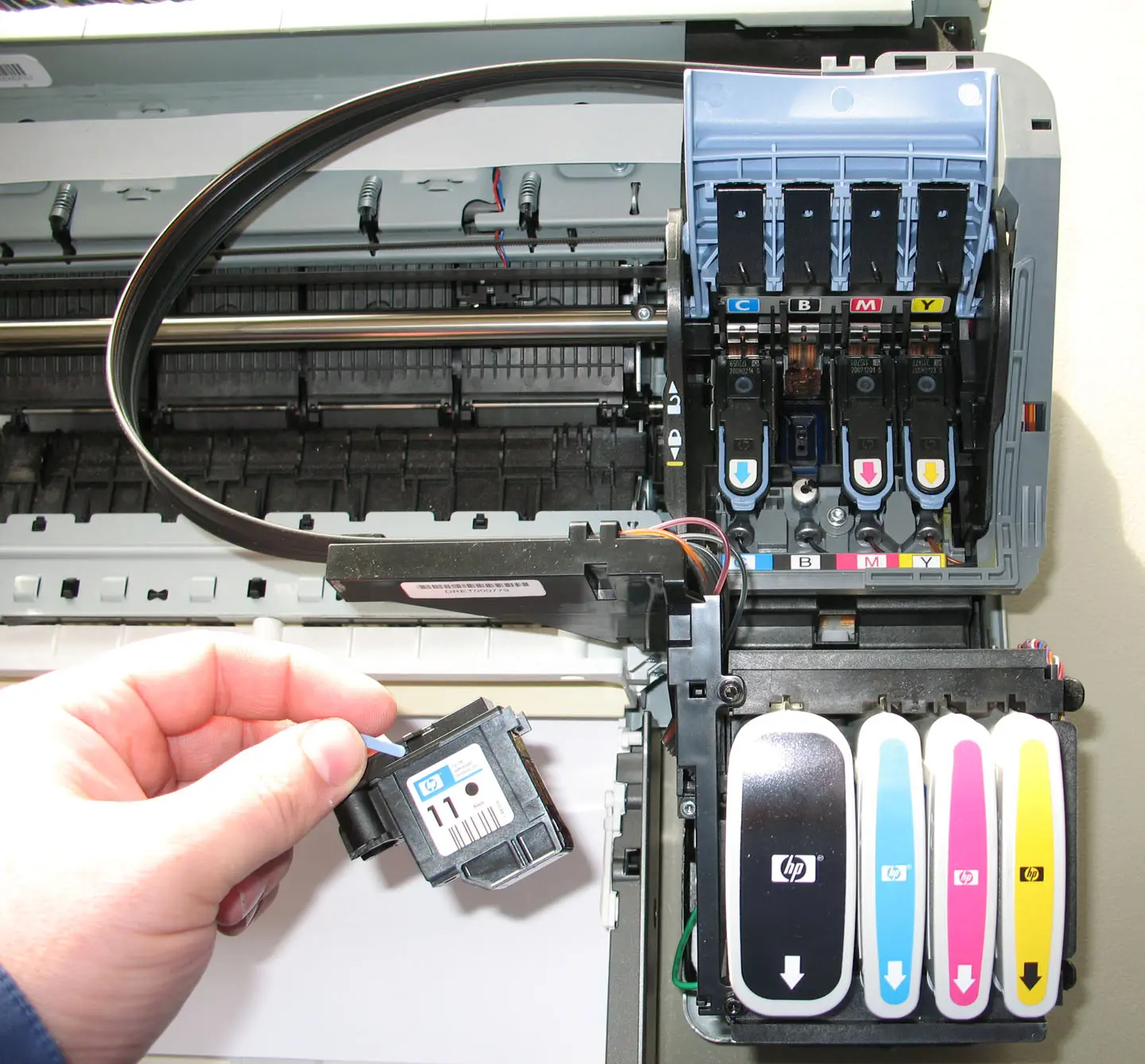 Zoom view of the carriage section of a HP aqueous inkjet printer CMYK ink heads with black head shown removed