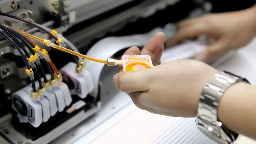 technician cleaning the inkjet head of a wide format printer