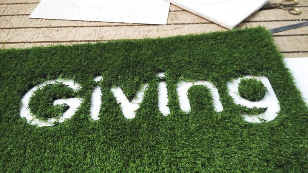 Unique interior decoration idea to cut a company logo in a grass carpet