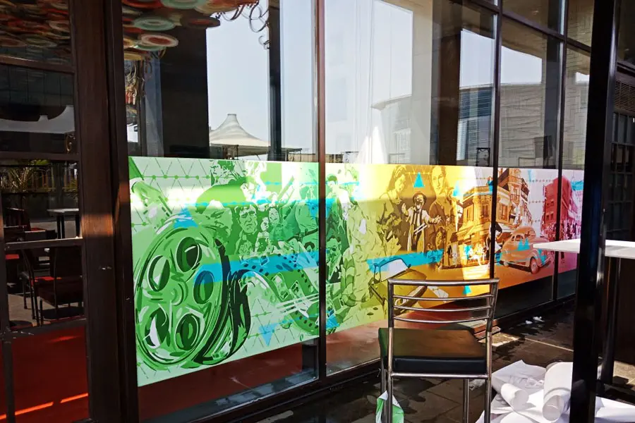 highly colourful movie themed opaque glass film print pasted on the front facade of a cafe to enhance the decor of the restaurant
