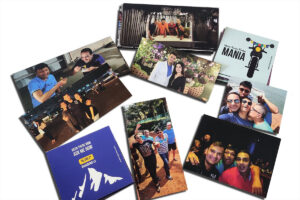 A number of pictures printed on magnetic sheets and spread out. These photo magnets make for highly personalised and unique gifts.