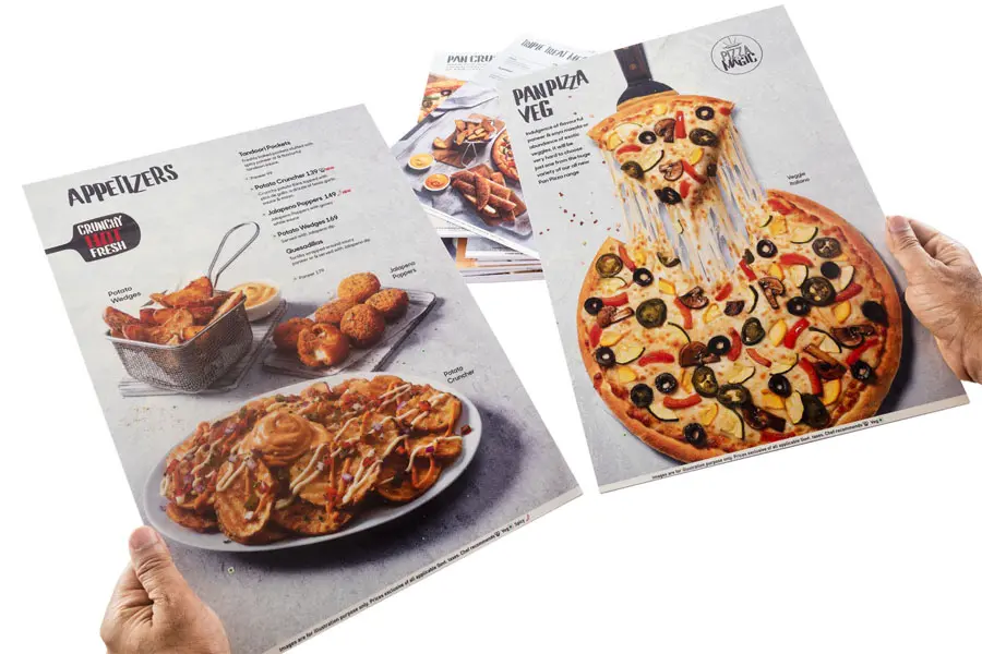 two laminated and waterproof restaurant menu cards made of rigid sunboard being held up