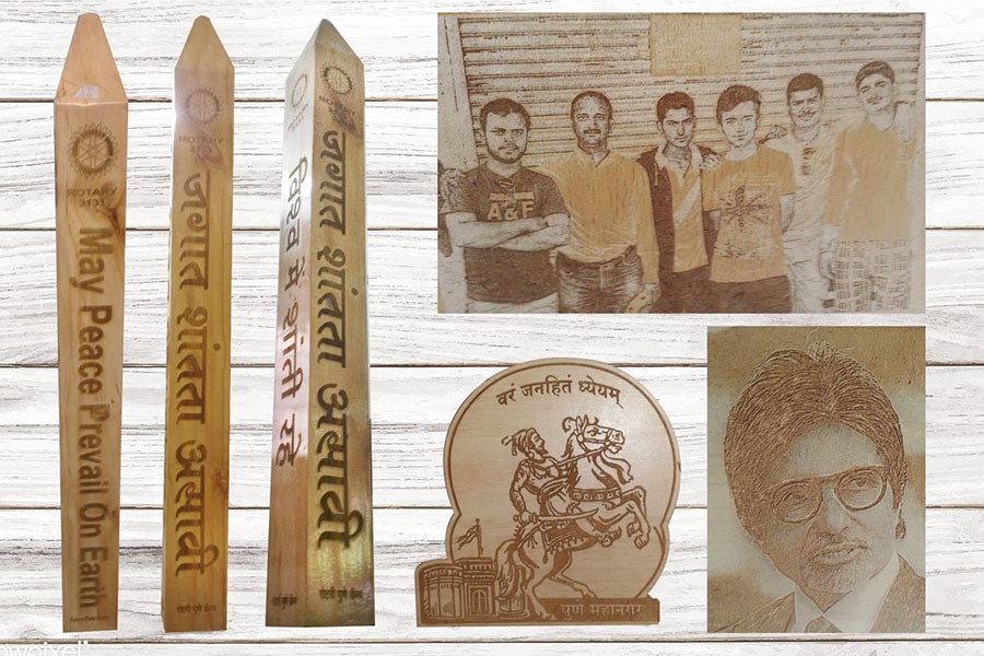 Photographs laser engraved on MDF, Pune University logo laser cut on wood and Rotaract Peace Pillar made of a carved wooden obelisk.