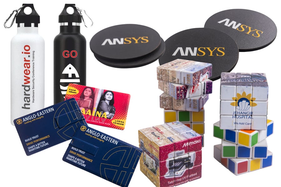 collage of UV printed personalised corporate gifts like a USB drive, tea coasters and rubik's cube