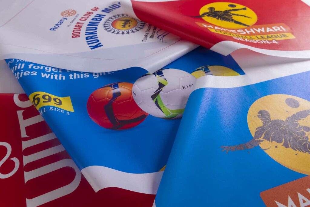 colourful flags and banners printed on cloth material spread out on a flat surface