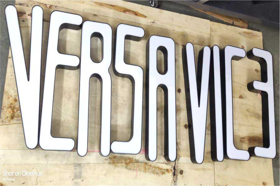 Black channel letters with a white acrylic front surface to create a beautiful sign board for a shop. Letters displayed on a wooden plank spelling out the words Versa Vice