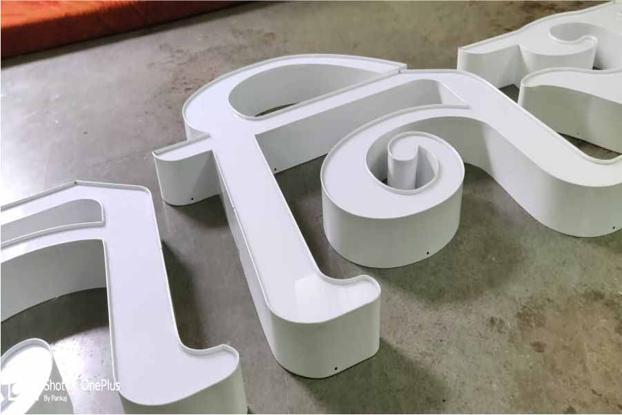 Side view of metallic channel letters fabricated from white aluminum side strip and white acrylic fitted on the top. Channel letters are great for creating beautiful looking LED glow sign boards