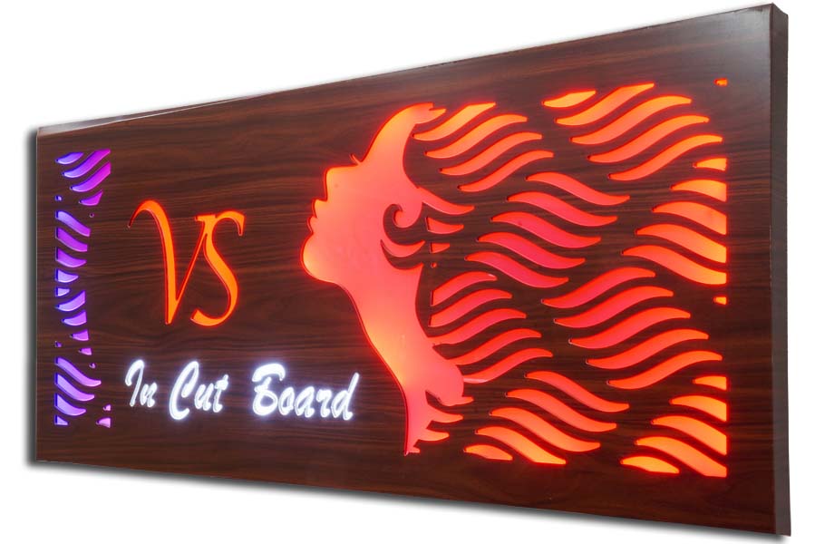 Stencil cut acrylic letters glow sign board for beauty salon. Outline of a woman cut lit in red LEDs with the letters lit in white LEDs.