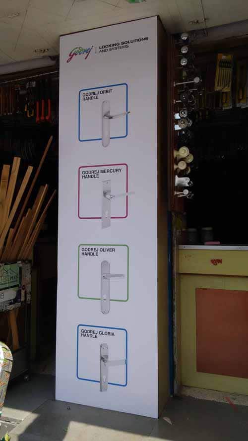 sunboard print pasted on a pillar of a store showing product images of godrej and boyce products