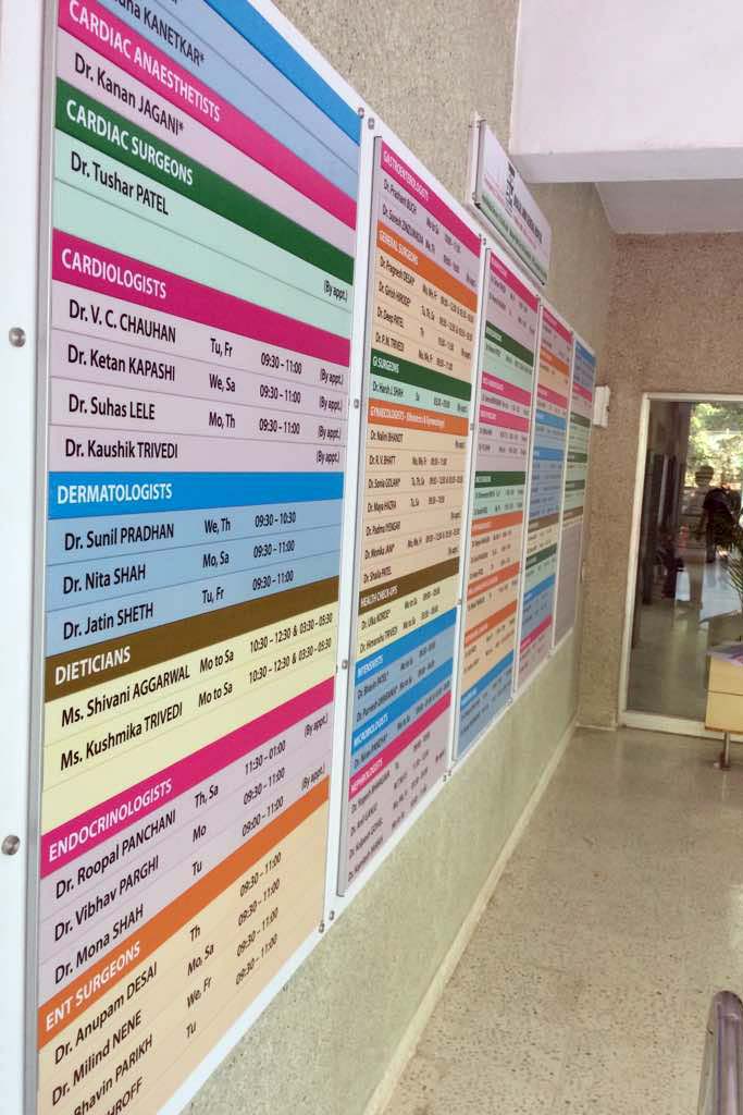 colorful lobby directory board displaying all the departments and employee names in the reception area of a hospital. Modular name board are a great idea for office interior design