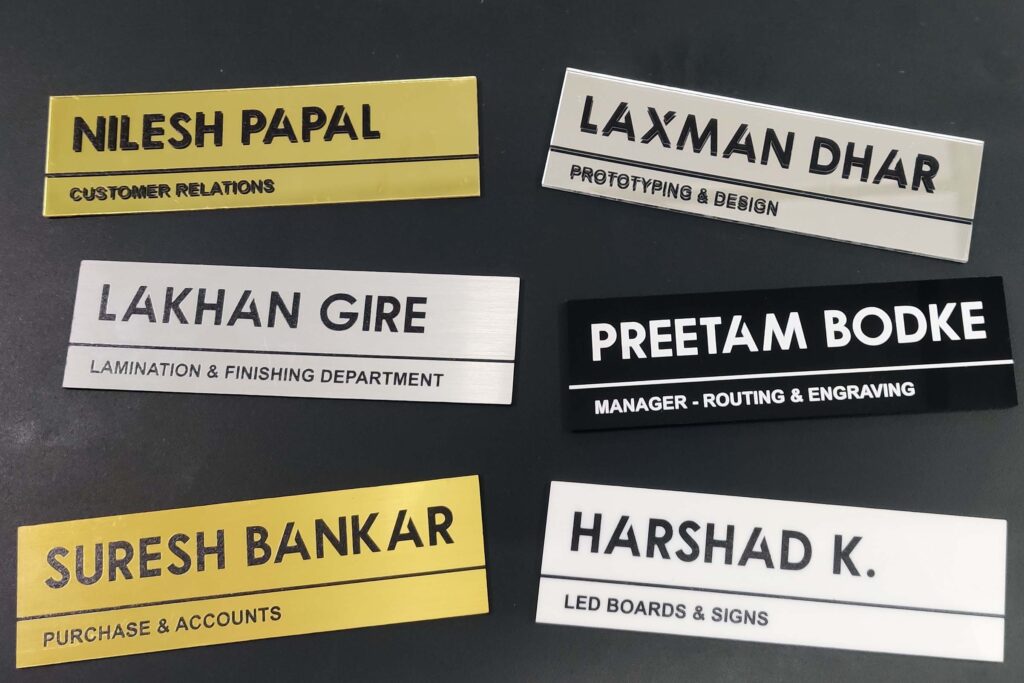 Office employee name plates made of different materials like silver and gold laser ply white and black acrylic sheets and even mirror finish reflective acrylic