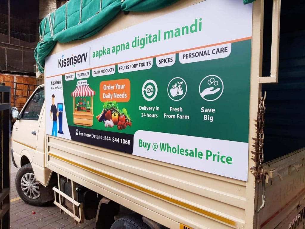 A printed ACP board used for vehicle advertising and van branding. The Kisan Serv product images and services displayed on the side panels of a Tata Ace, Chota Hathi van.