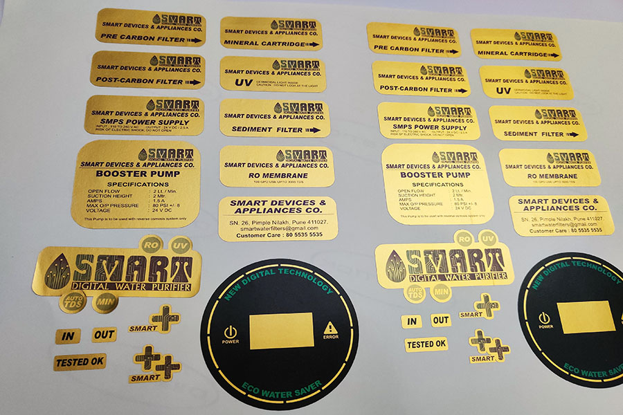 Golden stickers cut in various shapes laid out on an A4 sized sheet