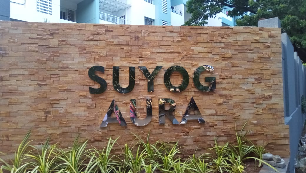 Metal letters fabricated in a chrome finish for the Suyog Aura society and fixed on the granite wall at the entrance