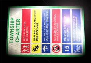 Retro reflective road sign charter of a township displaying do’s and don’ts to ensure safety of the residents