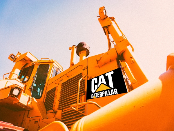 A view from the ground of earth moving equipment With the Caterpillar company logo pasted using weatherproof stickers