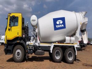 Scratch resistant and waterproof vinyl stickers displaying the Tata company logo pasted on a cement mixer parked at a construction site