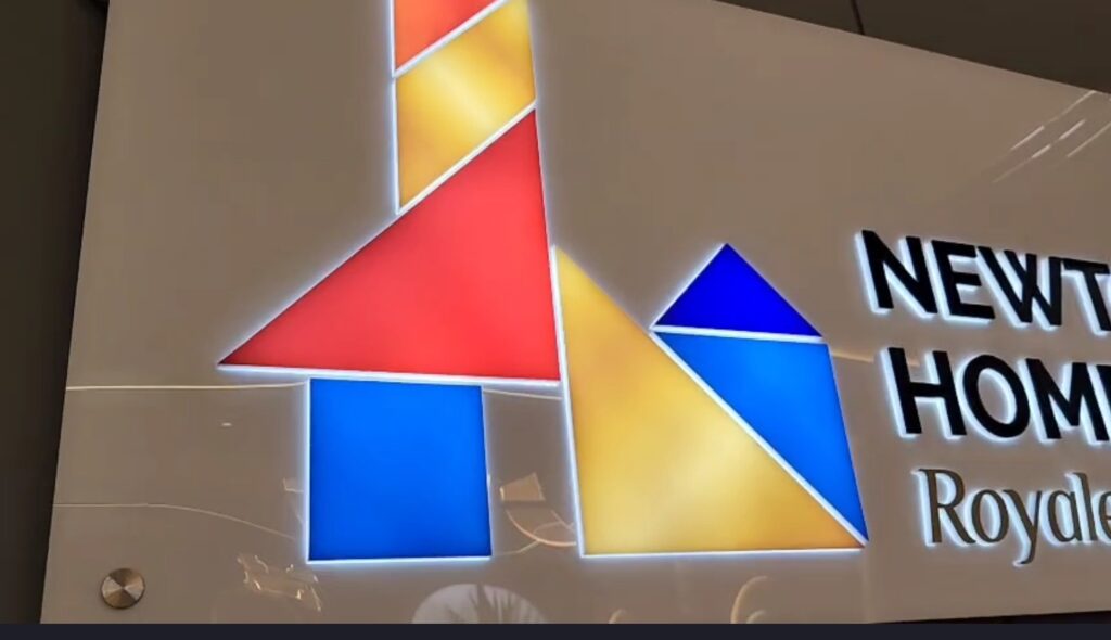 Brightly glowing company logo board displaying the company's logo made from laser-cut acrylic sheets, with LEDs embedded inside the sign.