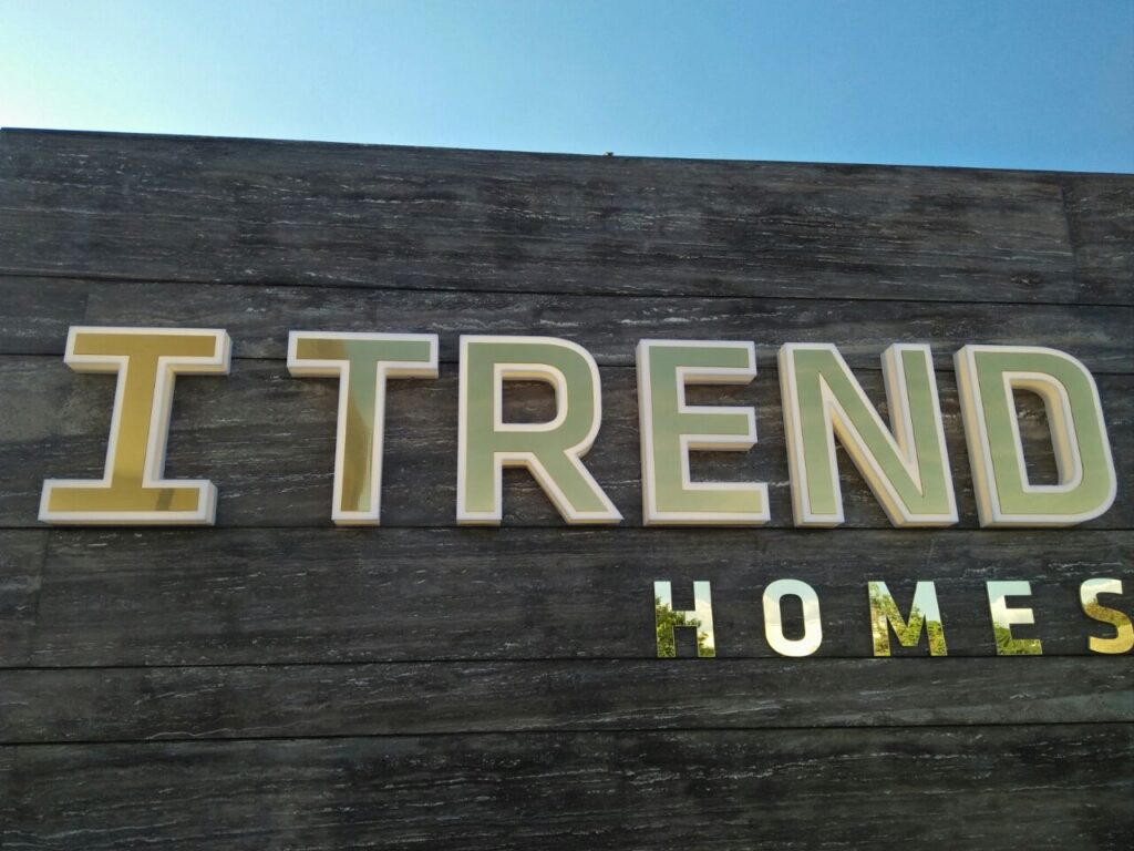 3D neon sign for 'I-Trend Homes' made of laser-cut acrylic letters, installed on an exterior wall of their building.