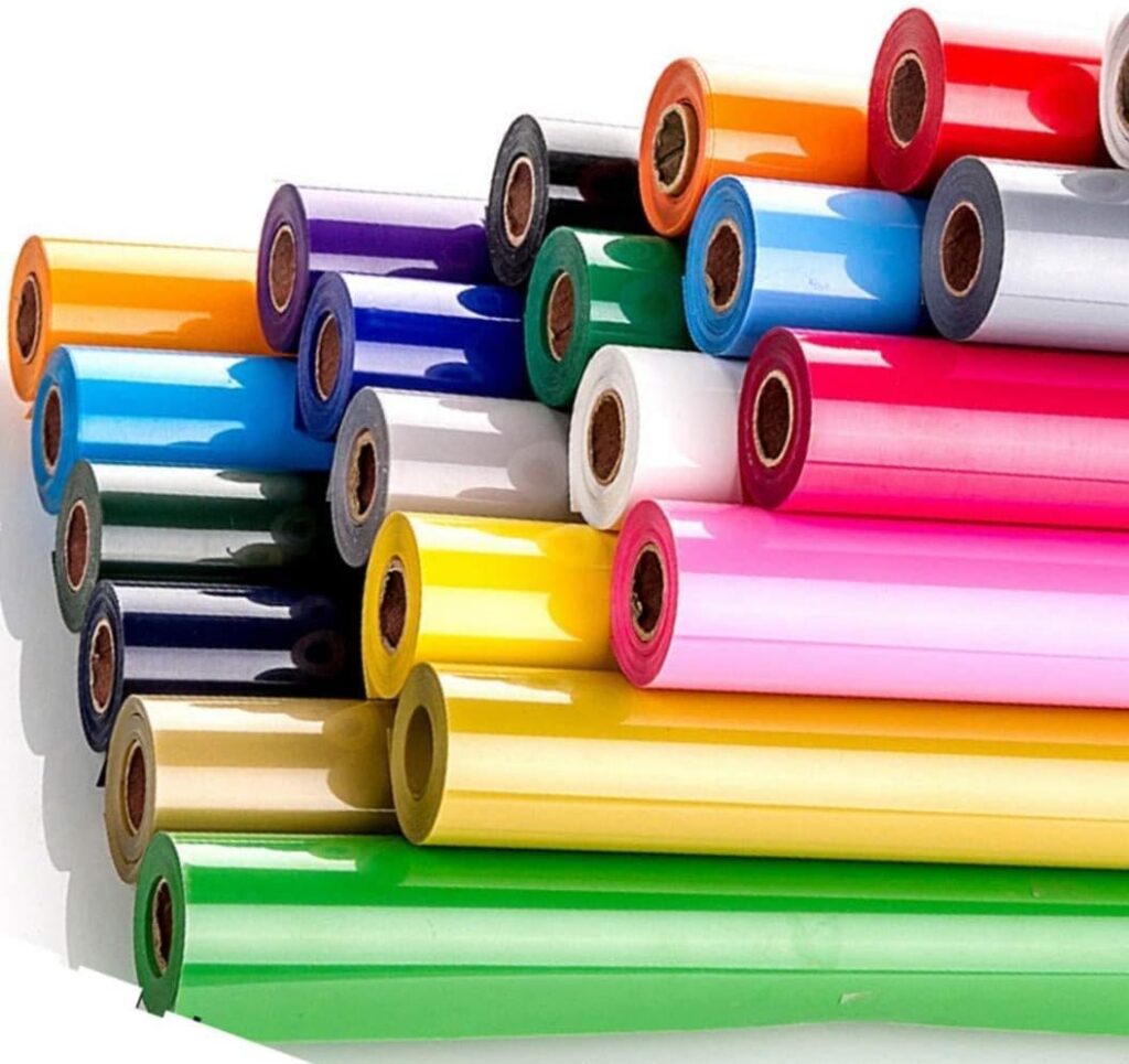 Multicoloured rolls of vinyl stacked on top of one another - these vinyl films assist in colouring laser-cut acrylic logos and signage.
